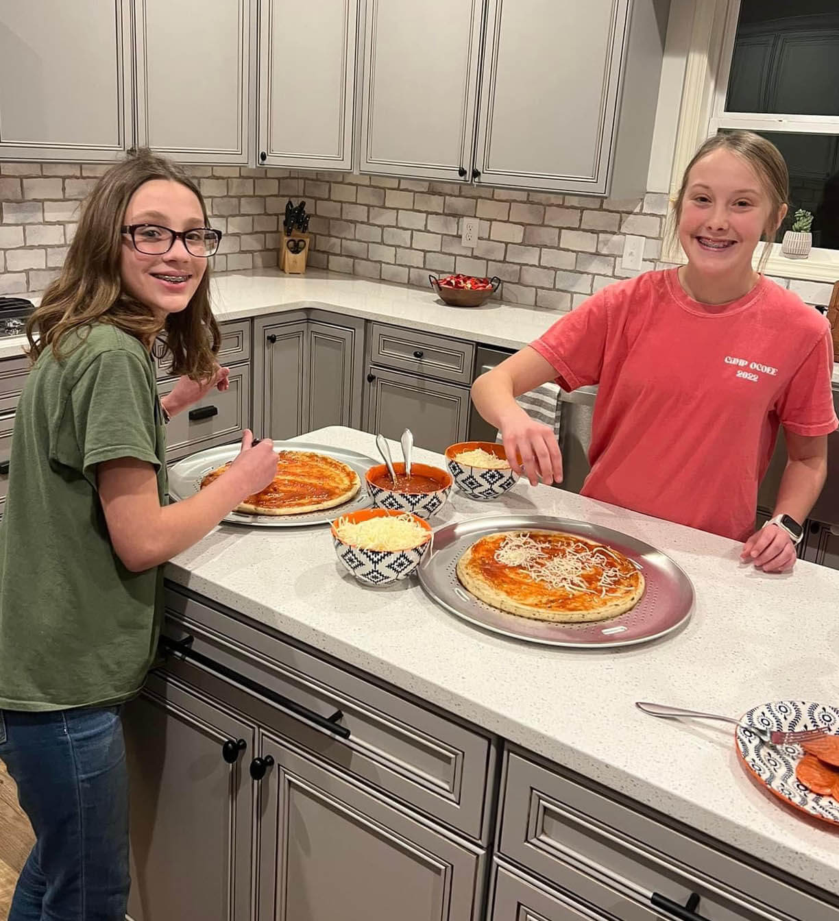 Kaylee and Makenzie making homemade pizza. Yum!
