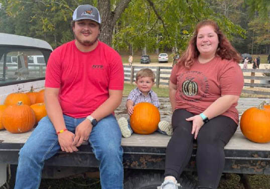 Hallie with Casey and their son, Bryce, at the Pumpkin Patch